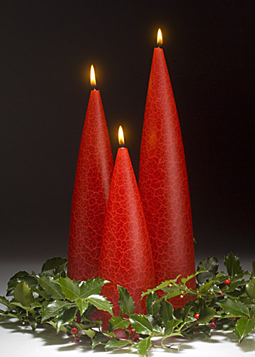 Christmas Red Candles burning in a Holly Wreath.